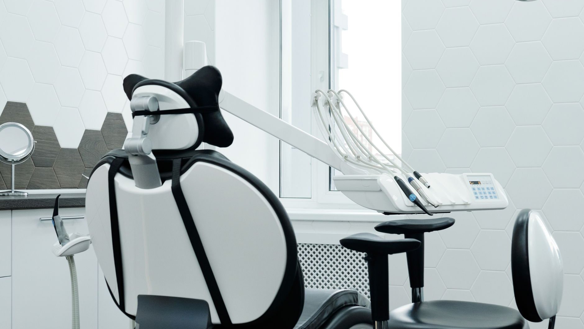 An empty dental treatment chair and lamp in a clinic room (illustrative stock photo)